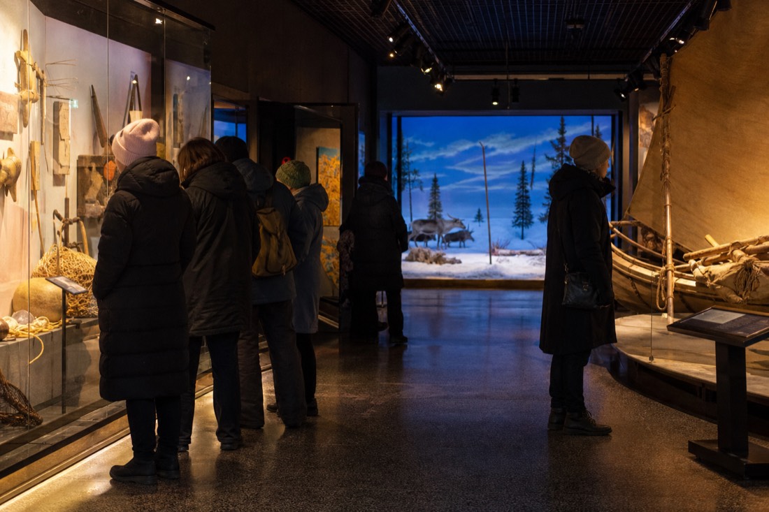 Warm interior of a northern museum gallery with visitors looking at exhibits on a cold day