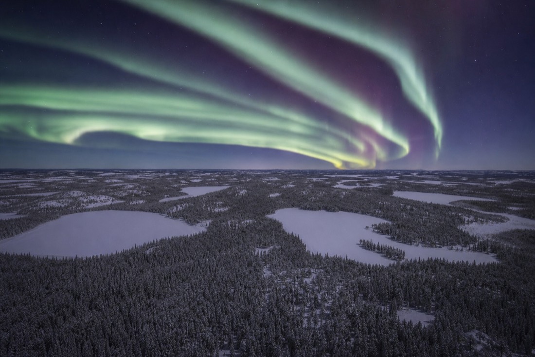 Aerial view of endless boreal forest and frozen lakes stretching to the horizon north of Yellowknife