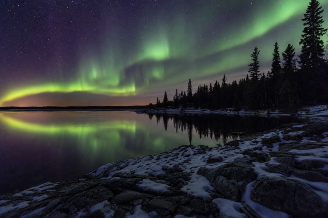 September aurora reflected in the open dark water of Great Slave Lake before freeze-up