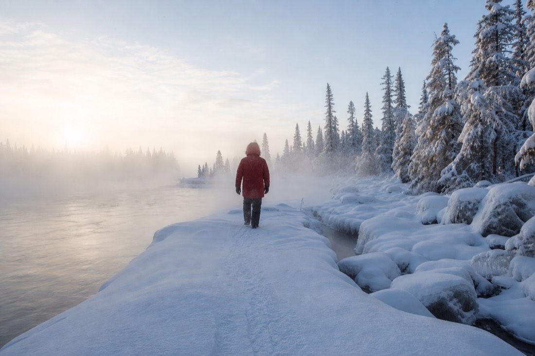 Person in a rented red arctic parka walking through ice fog on a bright frigid morning
